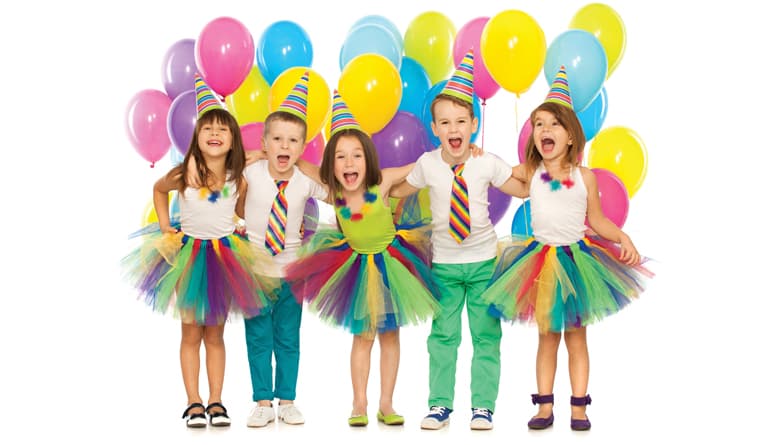 Children celebrating a birthday with colorful balloons and party hats